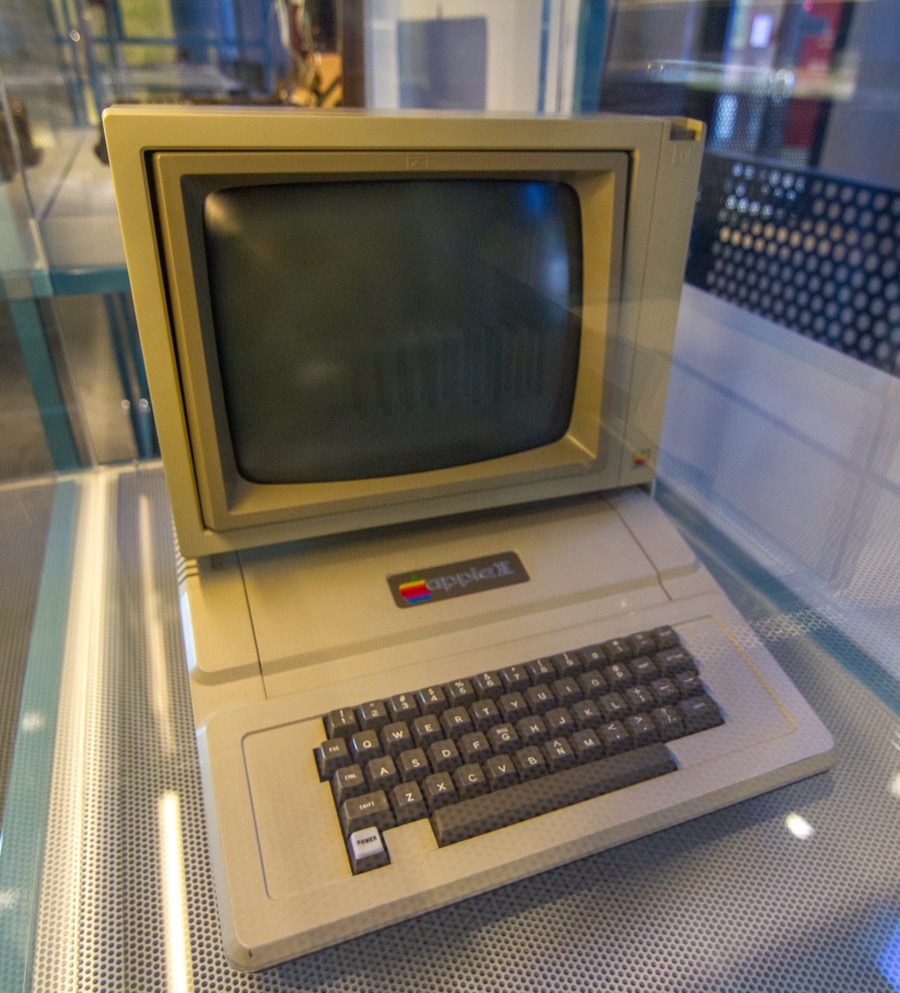 Apple II computer with monitor on display showing the complete system