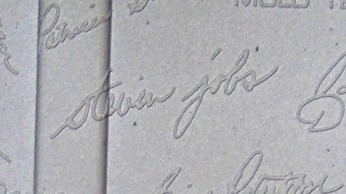Engraved signatures of the Macintosh team inside the original Macintosh case molding, including Steve Jobs, Bill Atkinson, Andy Hertzfeld, and Susan Kare