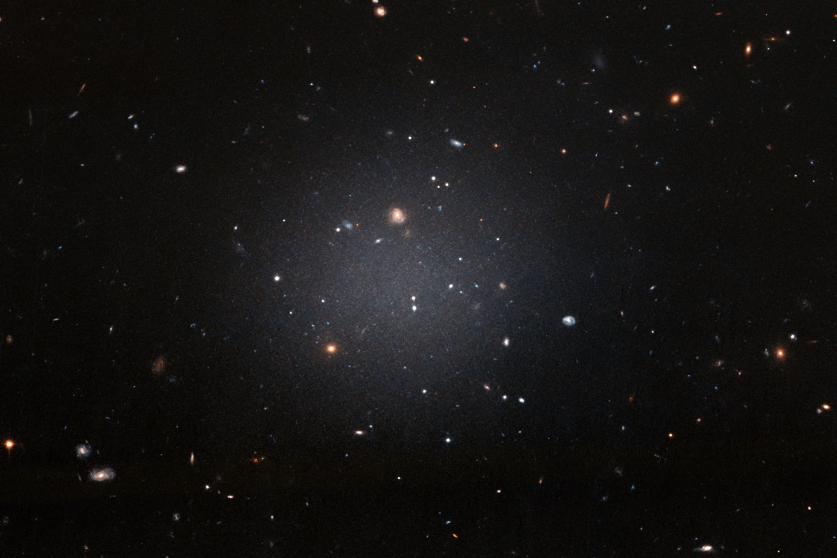 Hubble Space Telescope image of NGC 1052-DF2, a faint, see-through 'ghostly' galaxy that lacks dark matter - the prototype for the newly confirmed third dark-matter-free galaxy, NGC 1052-DF9